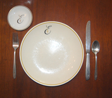 Dinner plate and butter pat in the Executive's pattern.