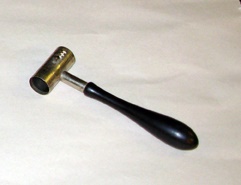 Wooden handled item with plated metal tube and slot with notches on tube.