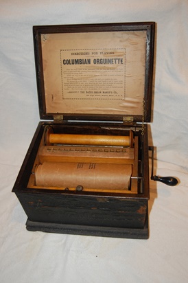 Paper roll loaded in organ and ready to attach to spool that is cranked.